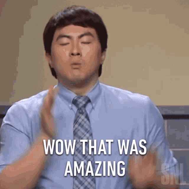a man in a blue shirt and tie says wow that was amazing in white letters