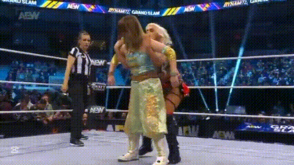 a couple of women are wrestling in a wrestling ring .