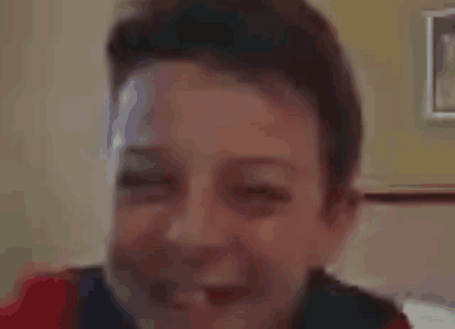 a close up of a boy 's face with a blurred background .