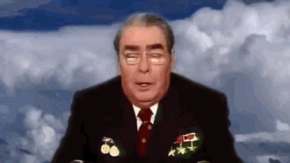 a man in a suit and tie with medals on his chest