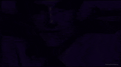 a close up of a man 's face with a purple border