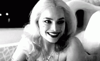 a black and white photo of a woman in a bathtub .