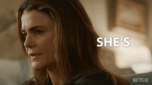 a close up of a woman 's face with the words she 's behind her