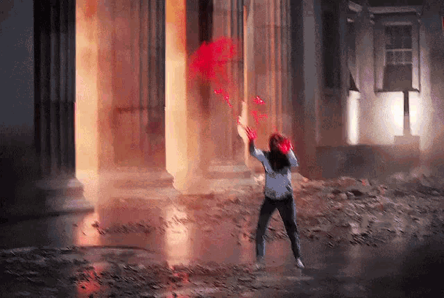 a woman is standing in front of a building holding a red balloon