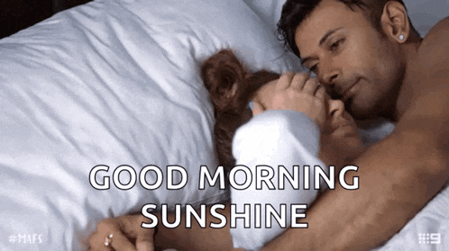 a man and woman hugging in bed with the words good morning sunshine written above them