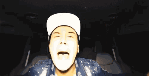 a man wearing a white hat is making a funny face