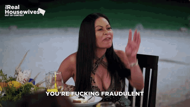 a woman sitting at a table with the words you 're fucking fraudulent