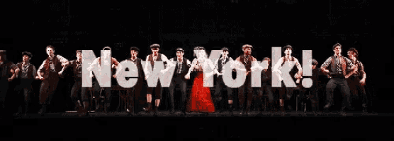 a group of people are standing in front of a sign that says new york