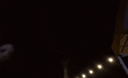 a person is holding a piece of paper in their hand in a dark room