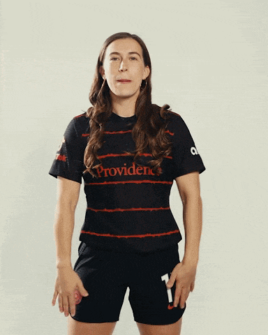 a woman wearing a providence jersey and shorts