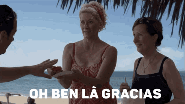 two women standing on a beach with the words oh ben la gracias in white letters