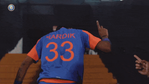 a man in a blue and orange jersey with the number 33 on it