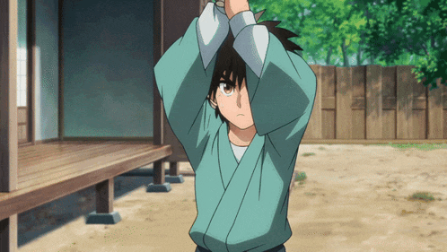 a boy in a blue kimono is standing in front of a wooden building