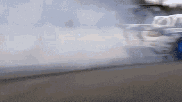 a car is driving down a road with smoke coming out of it