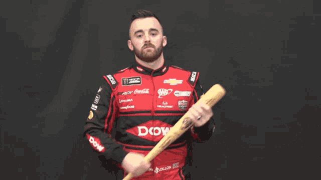 a man in a racing suit with the word dow on the sleeve