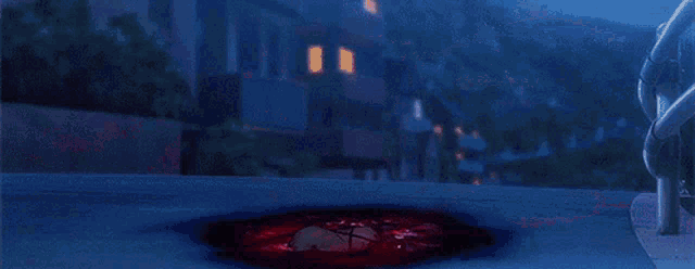 a girl in a red dress is kneeling on the ground in front of a building .