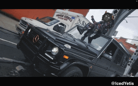 a man is standing on the roof of a black mercedes