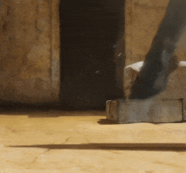 a shadow of a person is cast on a brick wall