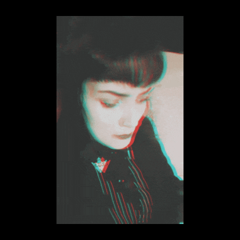 a blurry picture of a woman 's face with a red and blue glow