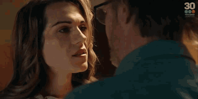 a man and a woman are looking at each other and the woman is asking how