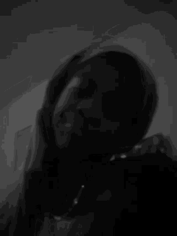 a black and white photo of a woman 's face