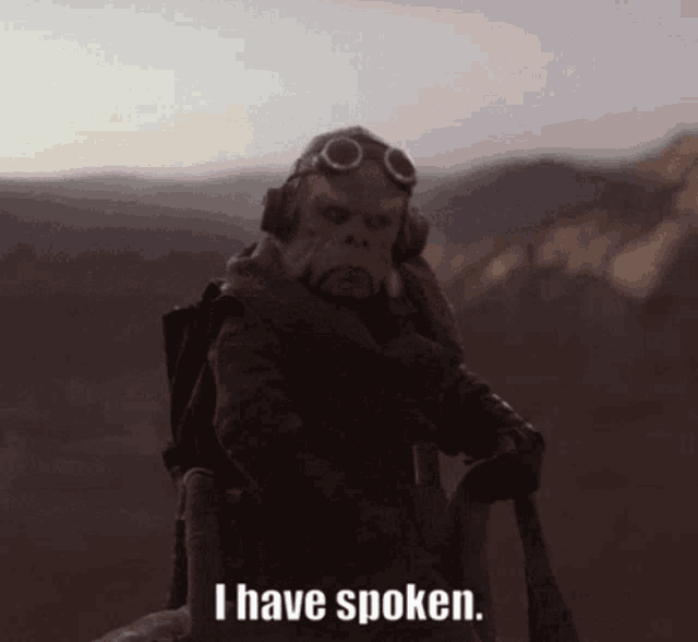 a man with a gas mask and goggles says i have spoken