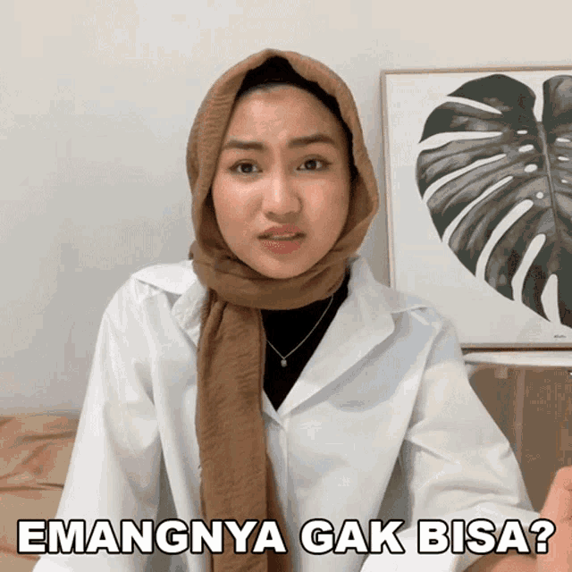 a woman wearing a scarf and a white shirt says " mangnya gak bisa "