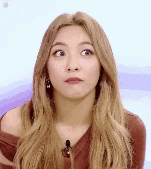 a close up of a woman making a funny face with her eyes closed