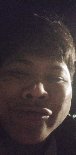 a close up of a person 's face with a dark background