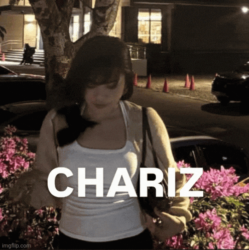 a woman in a white tank top is standing in front of pink flowers with the name chariz written on the bottom