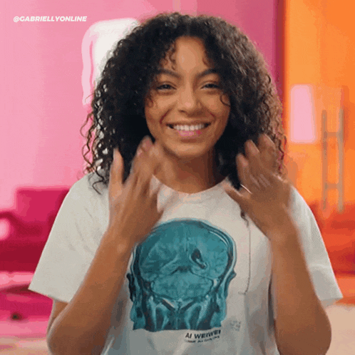 a woman with curly hair is wearing a t-shirt with a brain on it