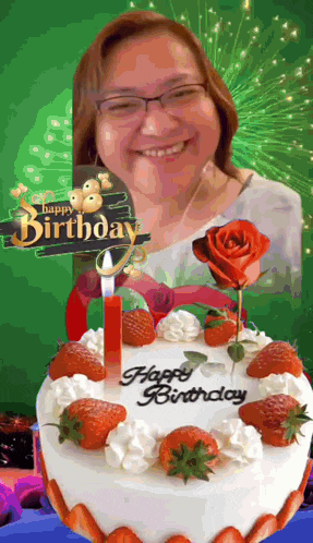 a woman is smiling in front of a birthday cake