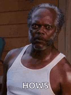 a man with a beard is wearing a white tank top .