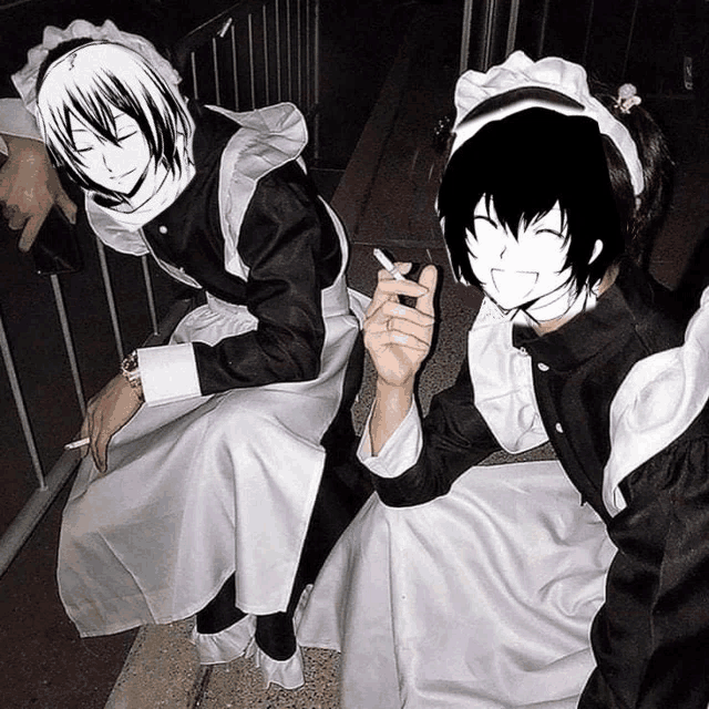 two people dressed as maids are sitting on a bench and one is smoking a cigarette