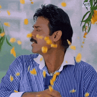 a man in a blue and white striped shirt is surrounded by yellow petals with xhk written on the bottom