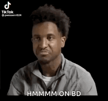 a man in a gray shirt is making a funny face and saying `` hmm on bd '' .