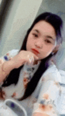 a blurry picture of a woman in a floral shirt