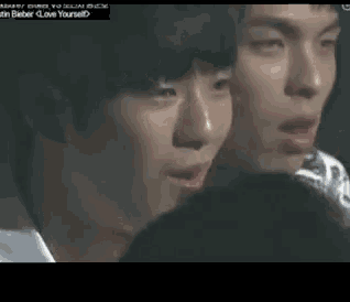 a close up of two men 's faces with the words love yourself on the bottom left