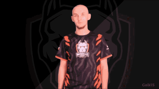 a man wearing a black and orange shirt with the word pit bulls on it