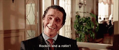 a man in a suit and tie is smiling and saying rockin ' and a rollin ' .