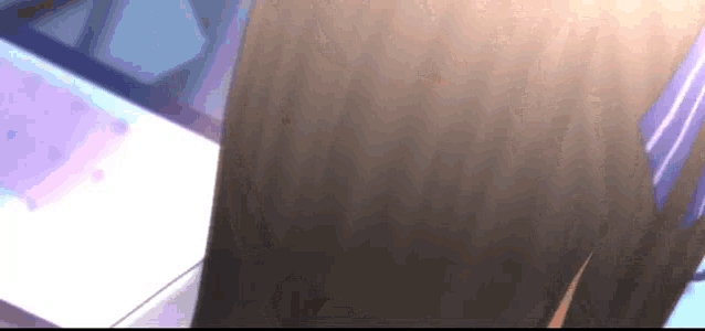 a close up of a person 's hair with a purple ribbon .