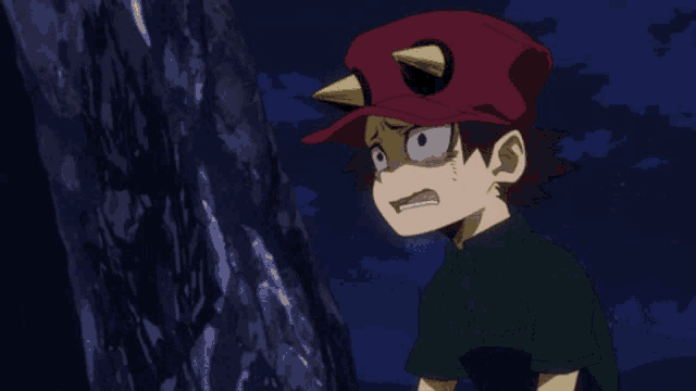 a young boy wearing a red hat with a yellow horn