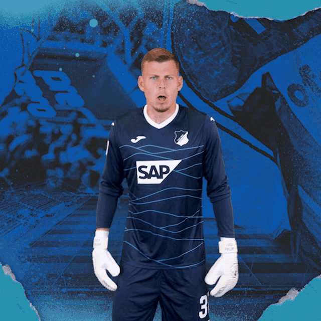 a man wearing a blue shirt with the word sap on the front