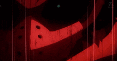 a close up of a person 's face with a red light behind them