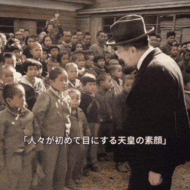 a man in a top hat stands in front of a group of children with chinese writing on the bottom