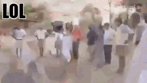 a blurry picture of a crowd of people walking down a street with the words lol .