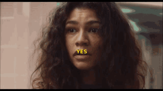 a close up of a woman 's face with the word yes on her mouth