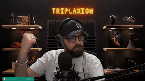 a man wearing headphones and a hat stands in front of a neon sign that says triplexxion