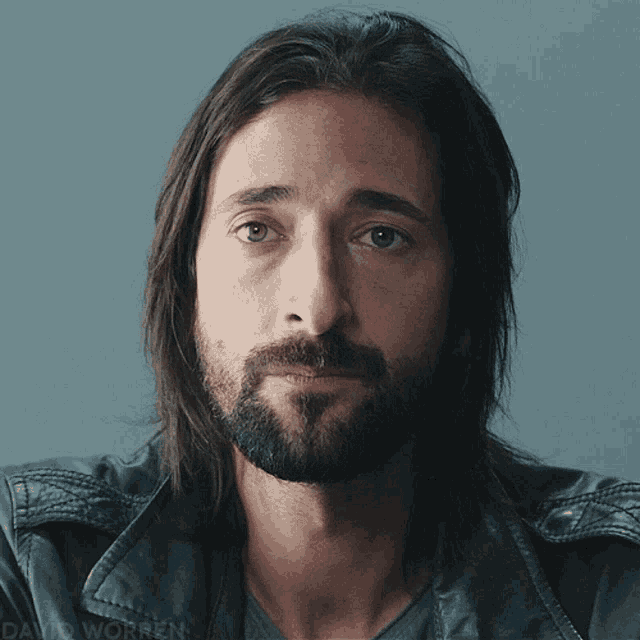 a man with long hair and a beard has david worren written on the bottom