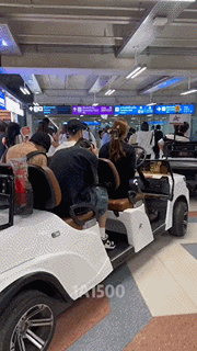 a group of people are sitting in a golf cart with the number 1500 on the bottom right